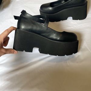 Black MJ platform shoes.
